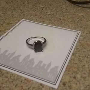 Black stone with silver band ring